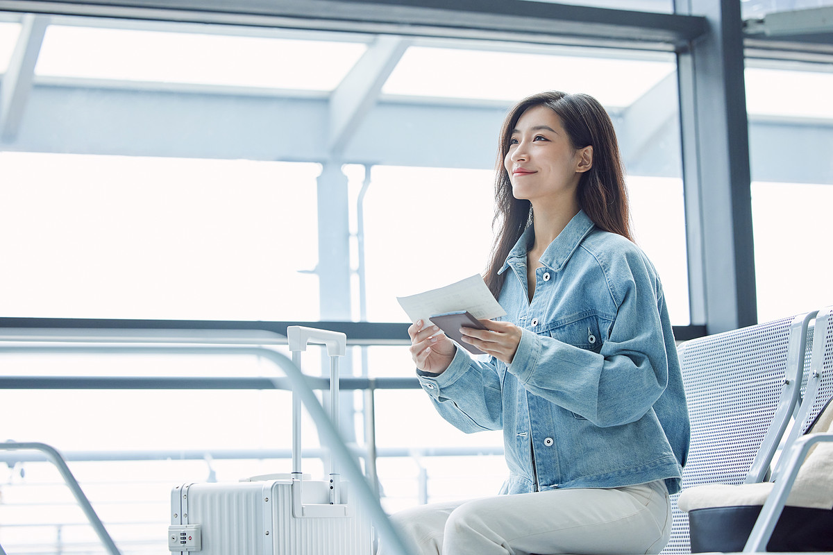 lovepik-young-female-holding-air-ticket-and-passport-picture_501789135.jpg
