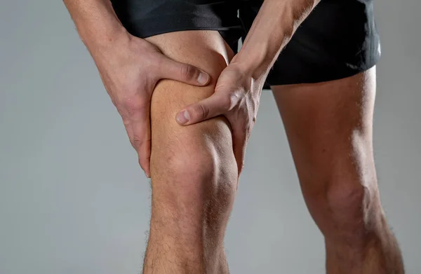 depositphotos_287843102-stock-photo-young-fit-man-holding-knee.jpg